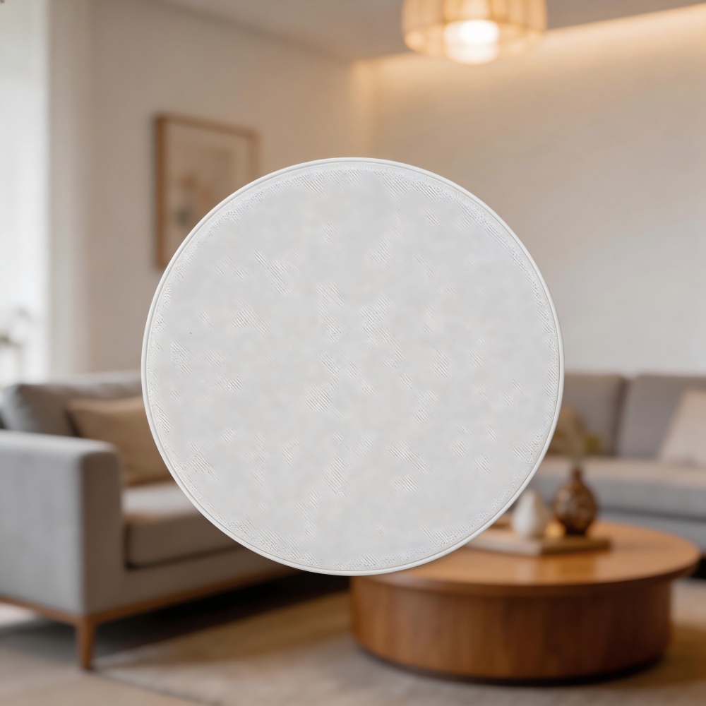 modern white ceiling speaker with acoustic fabric grill installed in minimalist living room ceiling